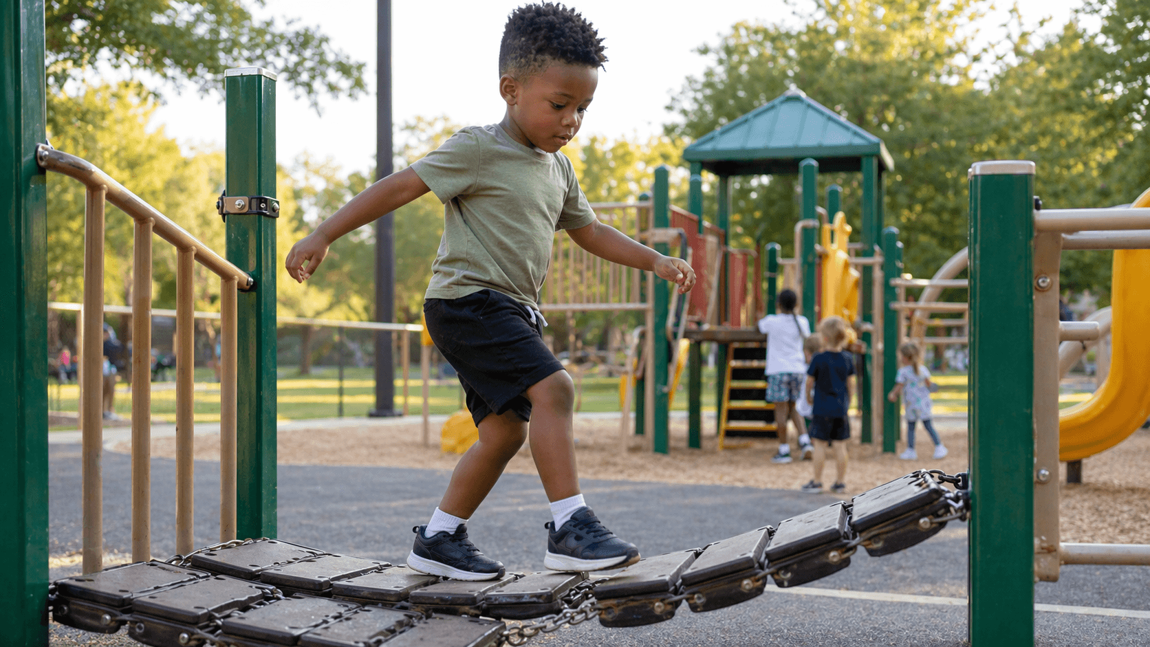Preschool-age child climbing playground equipment at a community park
